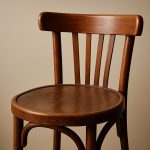 A close-up view of a wooden chair, highlighting its stylish design and craftsmanship.